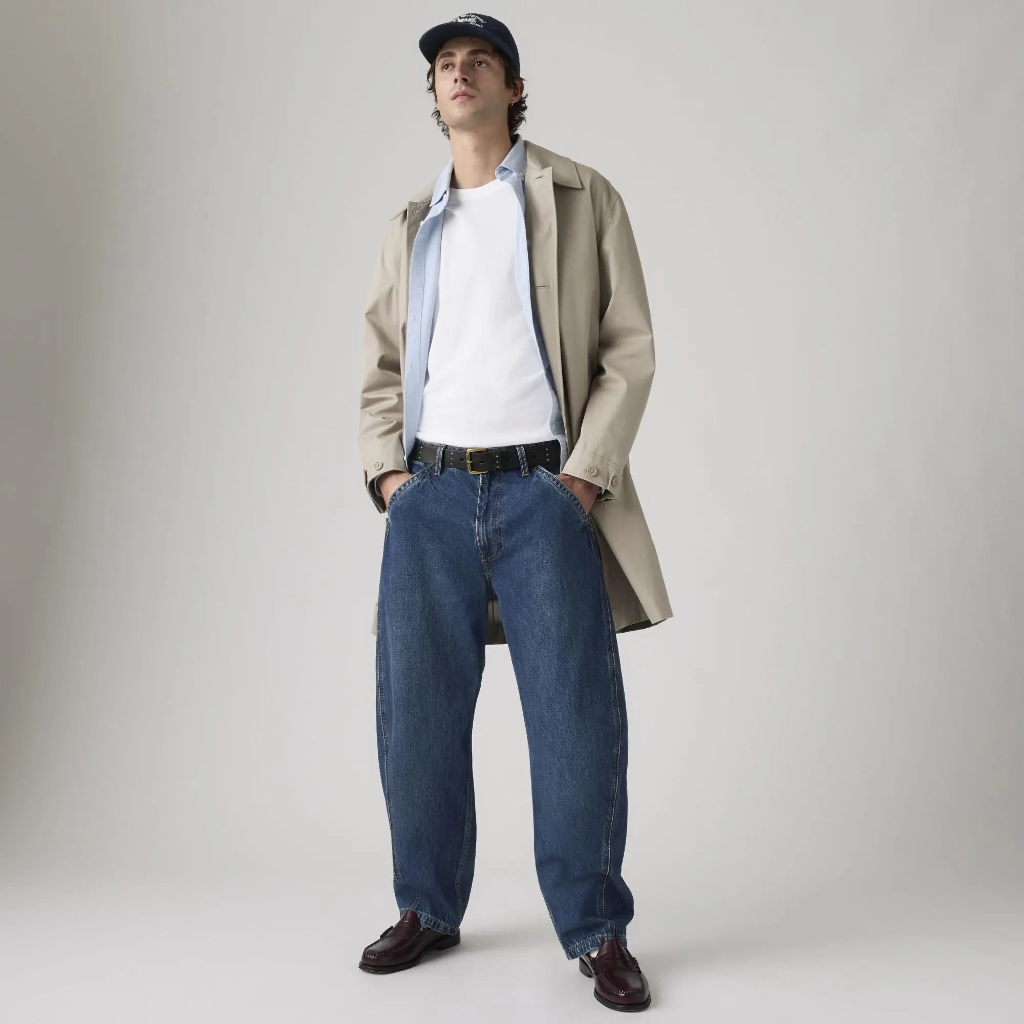Jean Levi's Baggy Barrel Max Volume porté avec un trench beige et des mocassins bordeaux, silhouette entière de face