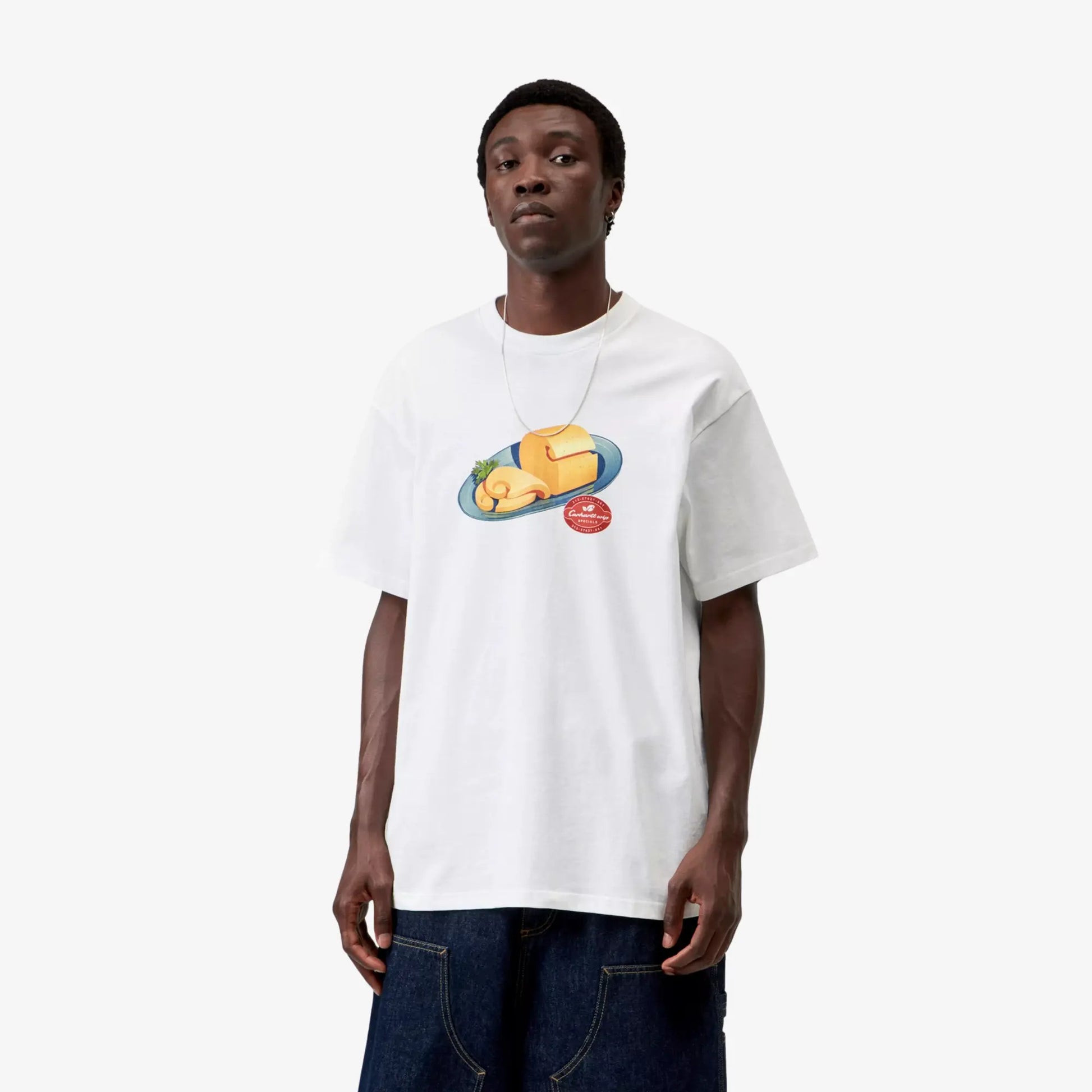 T-shirt Fromage blanc Carhartt WIP porté de face, coupe loose, épaules tombantes et imprimé assiette de fromage sur la poitrine