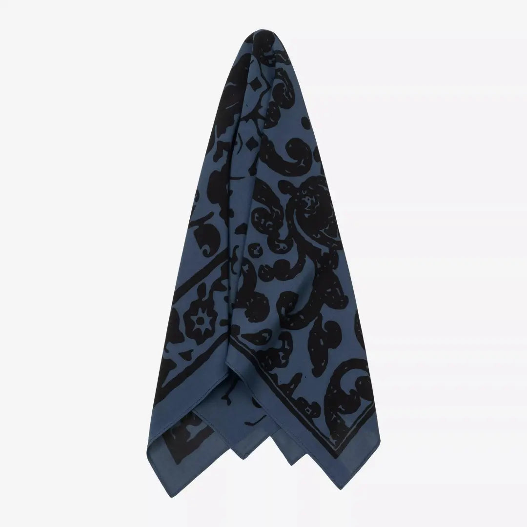 Bandana Vestige plié en pointe et suspendu, drapé bleu ardoise à arabesques noires et bordure fleurie
