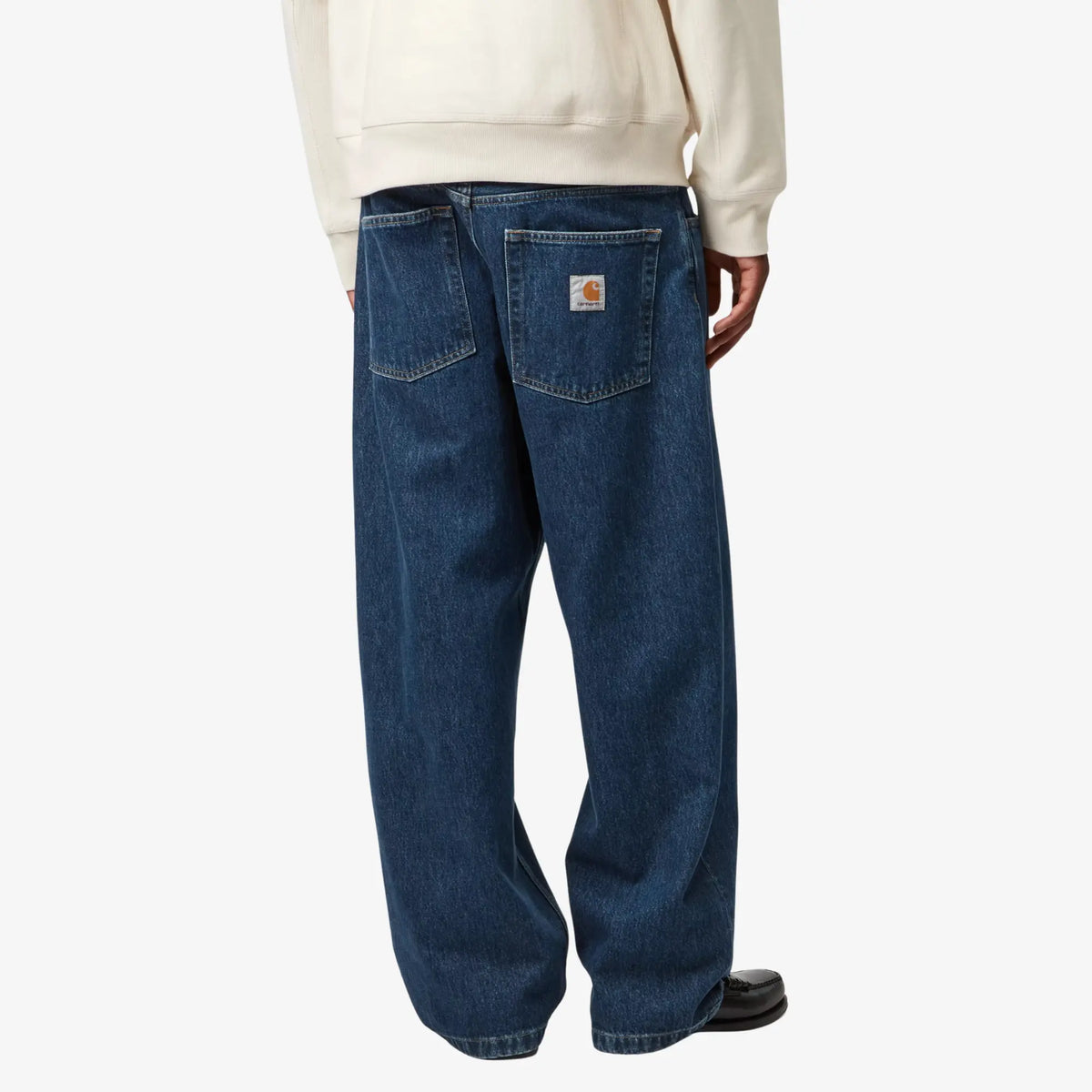Brandon Pant Blue Stone Washed porté de dos : patine claire autour des poches et de l'empiècement, jambes larges