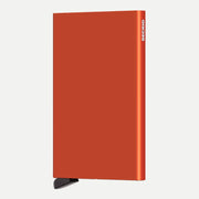 Porte-cartes aluminium orange brûlé de face, arête droite et poussoir noir en bas