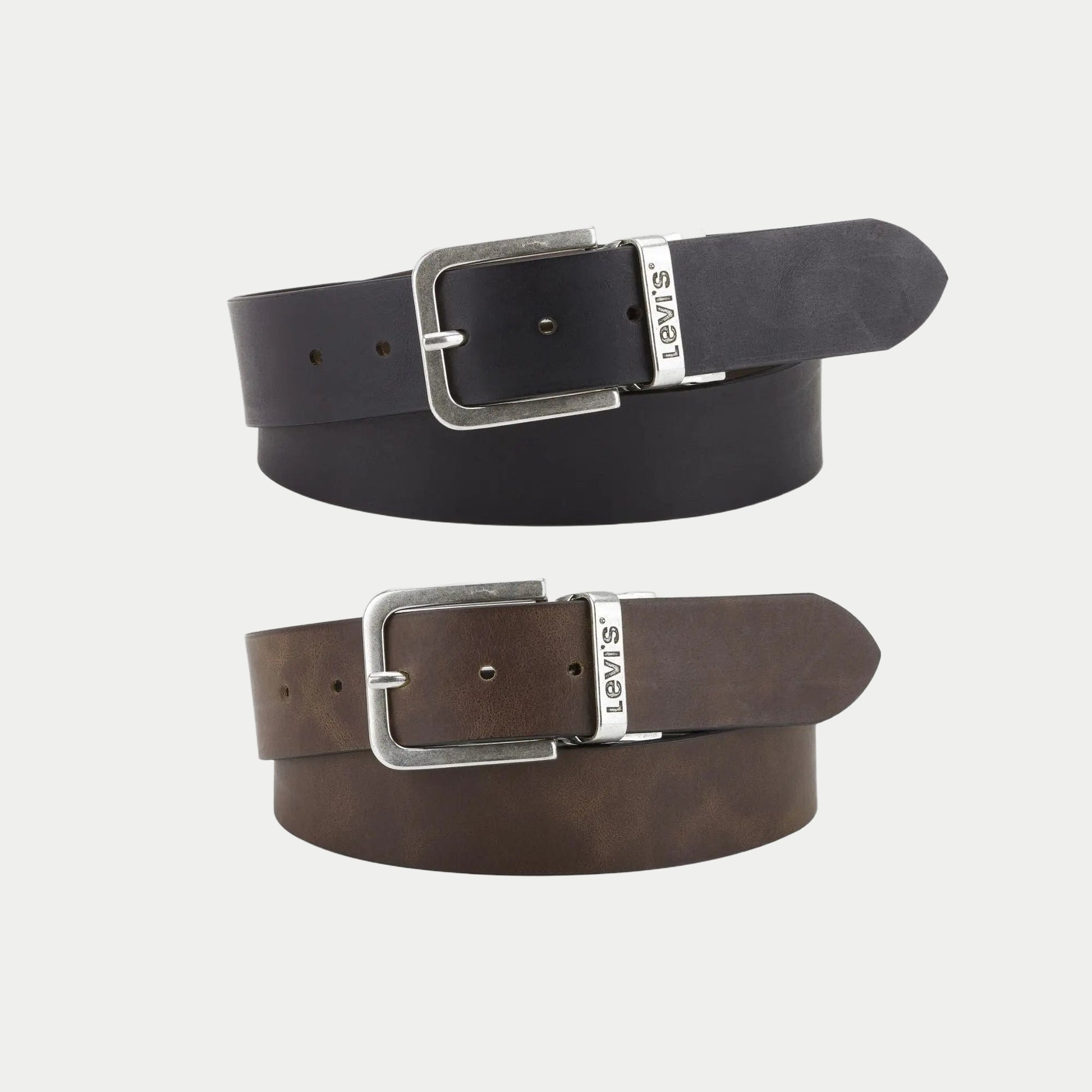 Ceinture Levi's Legacy réversible en cuir : face noire enroulée au-dessus de la face marron, boucle argent vieilli
