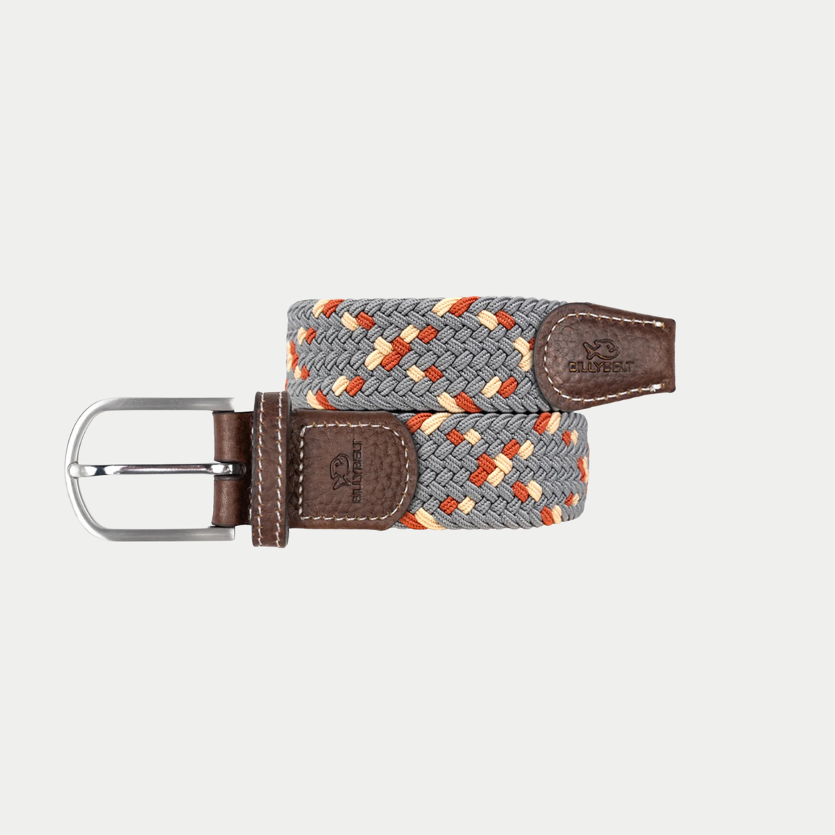 Ceinture tressée BillyBelt Atacama enroulée, tresse grise mêlée de beige et d’orange, embouts en cuir brun et boucle argentée.