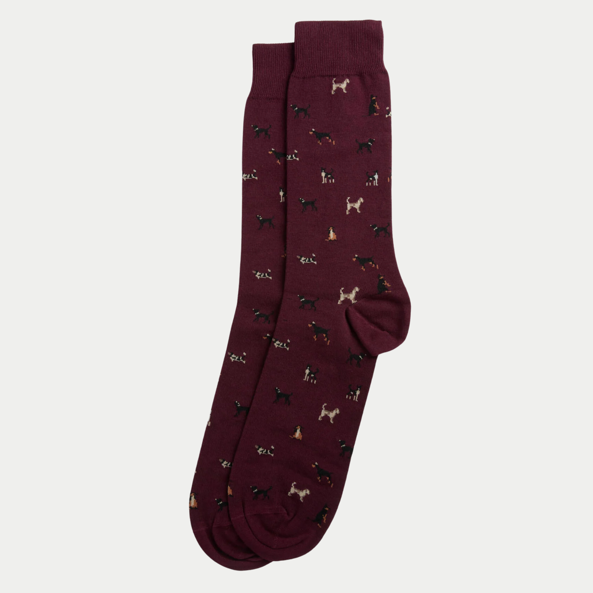 Chaussettes bordeaux chiné superposées et posées à plat, semées de petits chiens noirs, crème et fauve