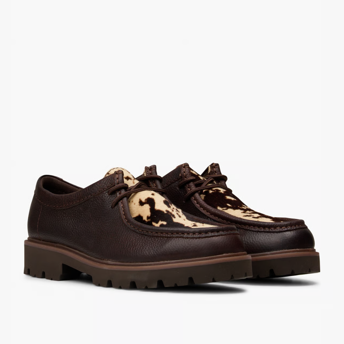 Paire de Cleyhill Seam Clarks imprimé vache vue trois-quarts avant, cuir marron et lacets cordés bruns