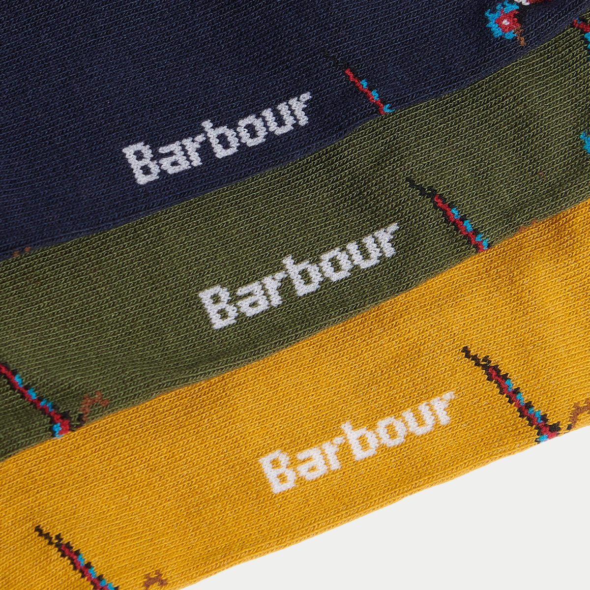 Détail du faisan tricoté et du nom Barbour sur les chaussettes vert olive, marine et moutarde