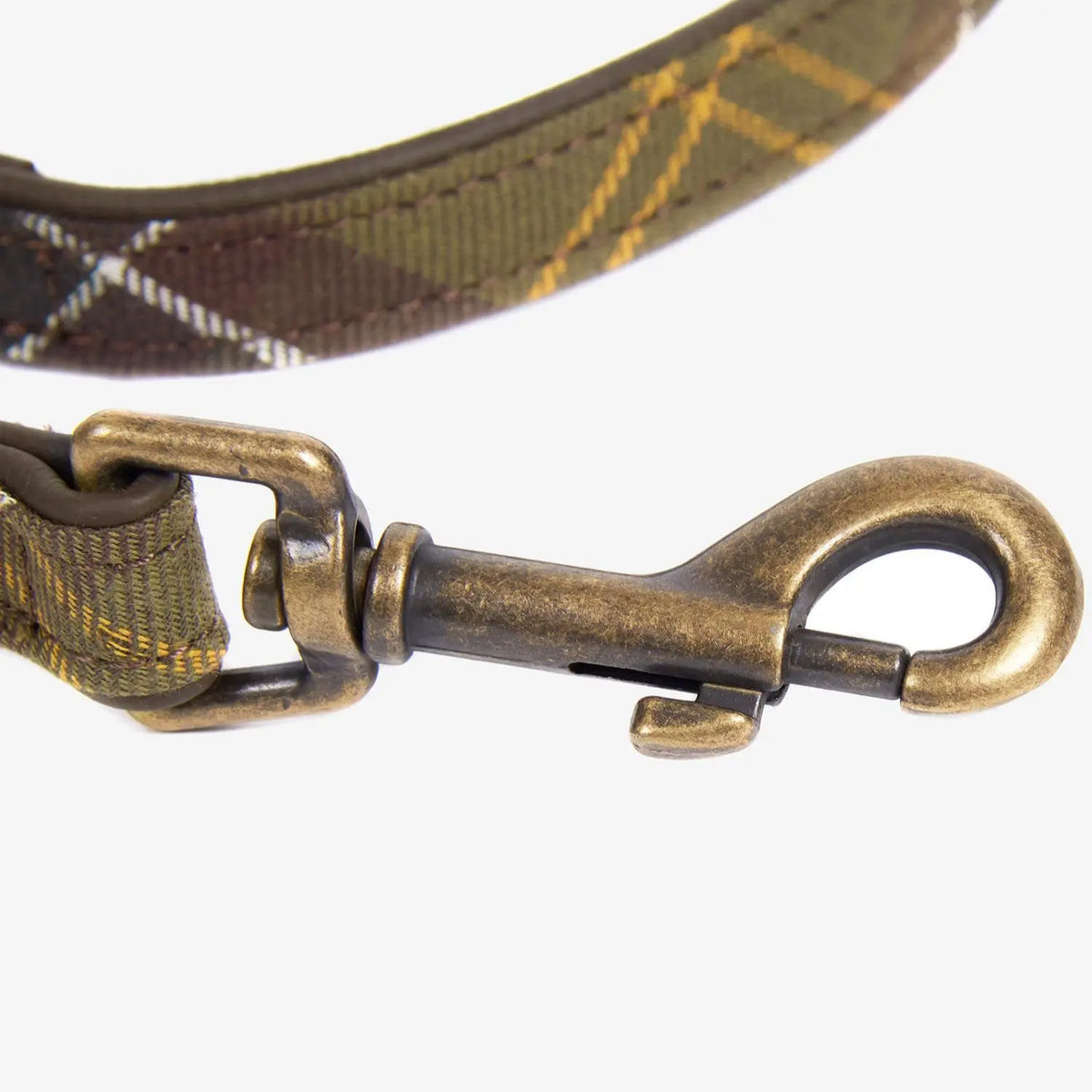 Macro du mousqueton pivotant en laiton vieilli de la laisse tartan olive et ocre