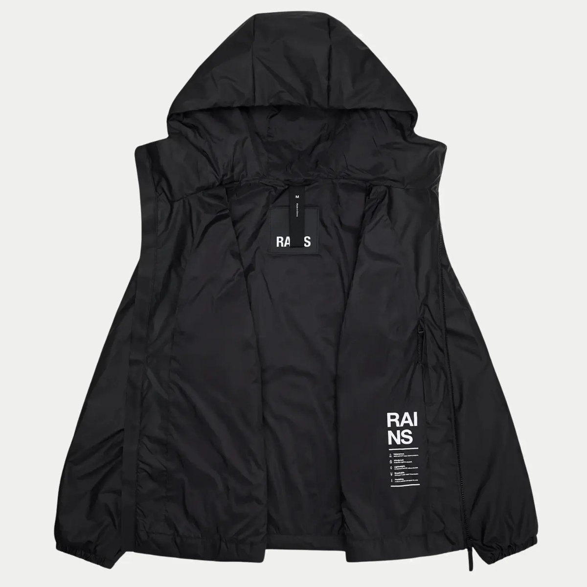 Lohja Insulated Jacket ouverte sur sa doublure noire, poche zippée intérieure et patch de marque