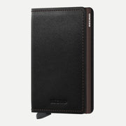 Portefeuille plat en cuir noir grainé, surpiqûres brunes et boîtier brun en tranche