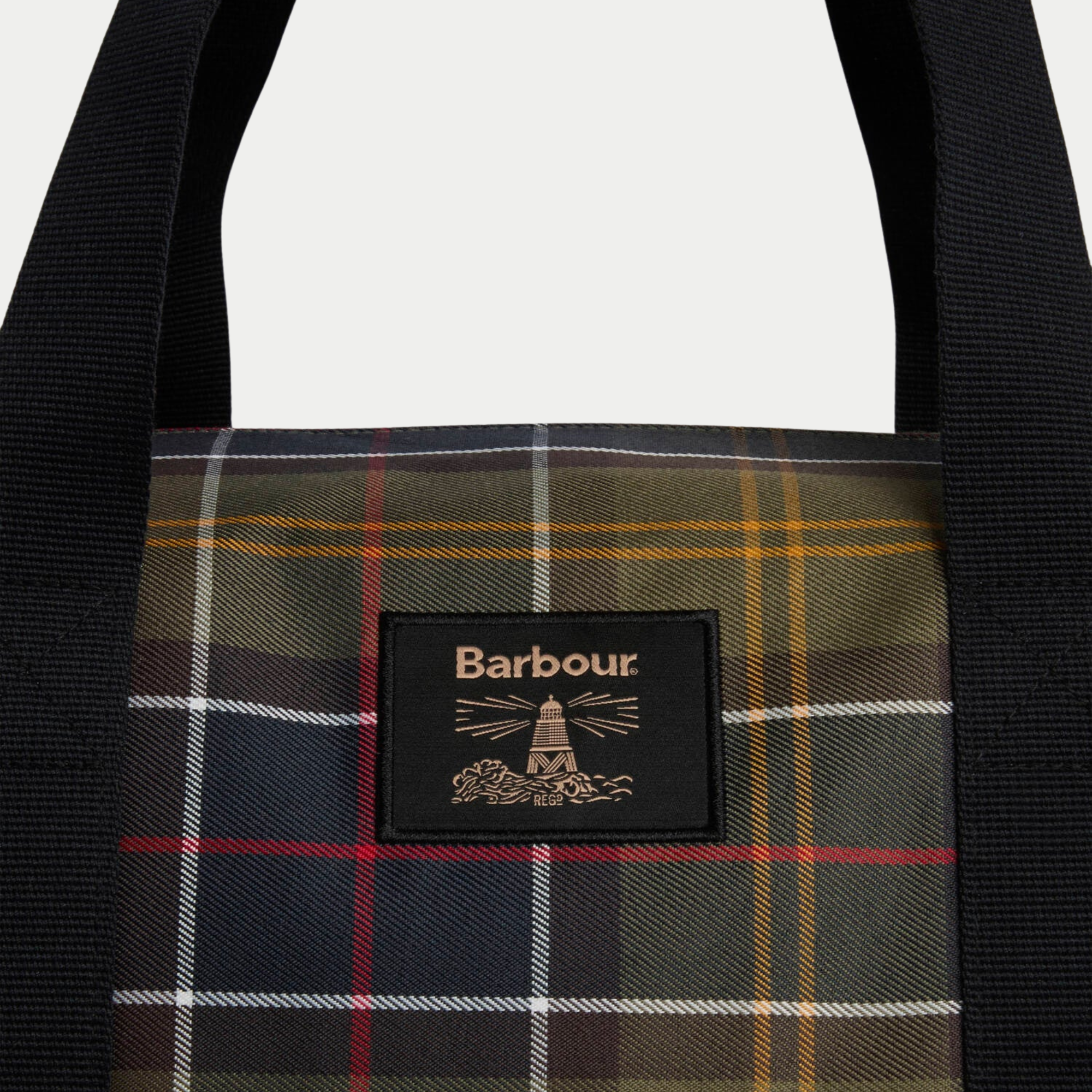 Patch phare Barbour brodé sur le tartan du sac Torridon, entre les deux anses en sangle