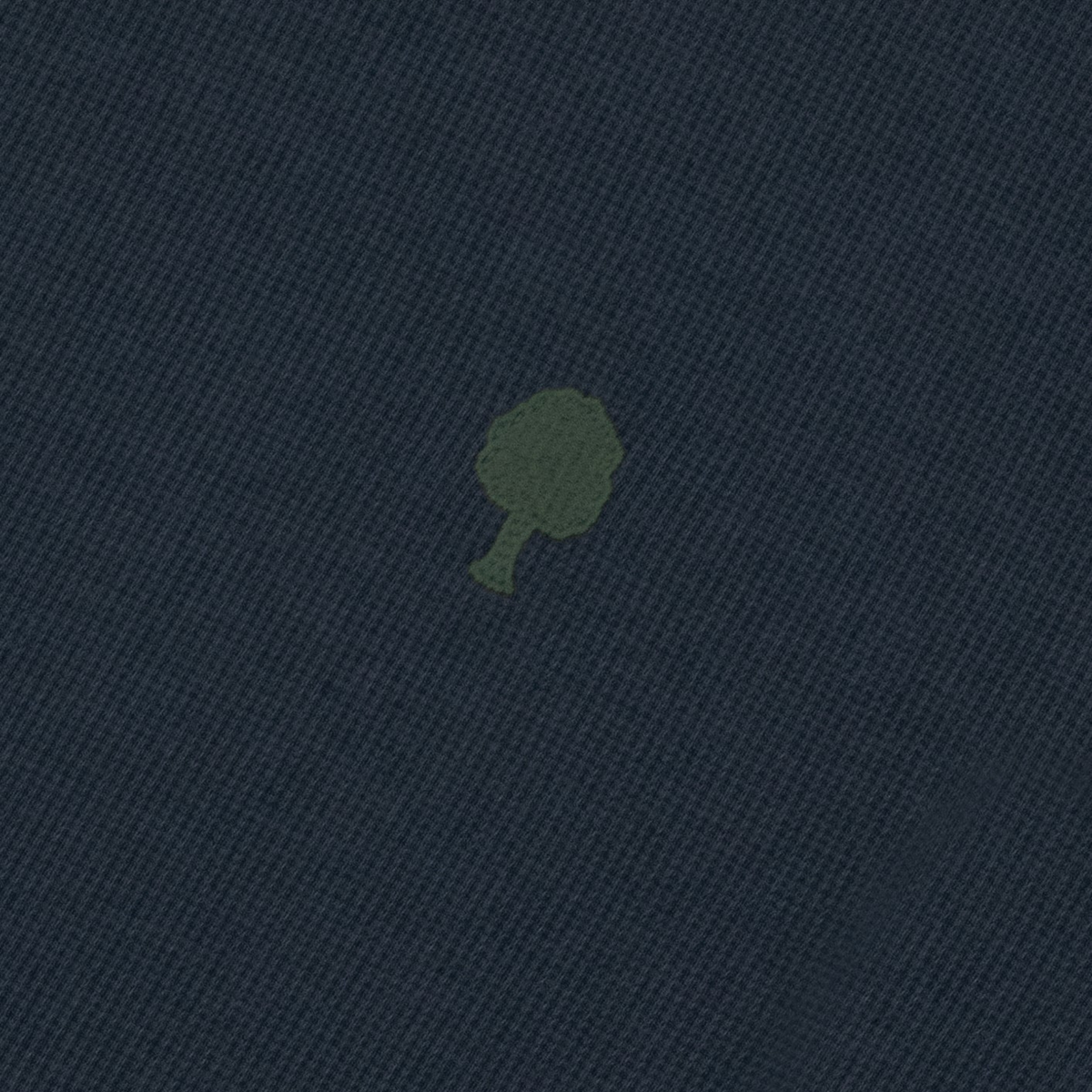 Détail de la maille piquée gaufrée bleu marine et de l'arbre brodé vert olive du t-shirt Bailly Faguo