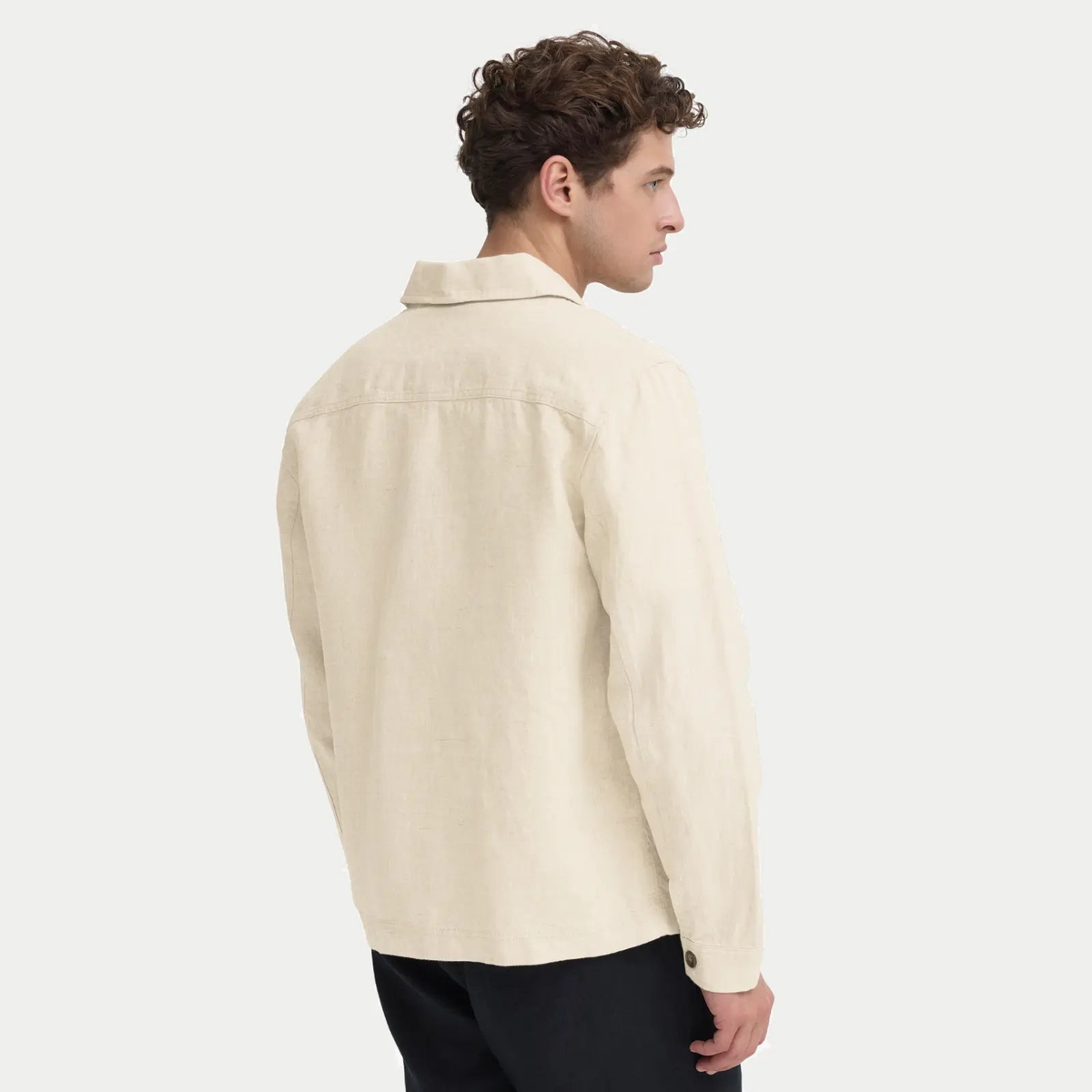 Veste en lin beige naturel vue de dos une fois portée, tombé souple du lin et fente de poignet boutonnée