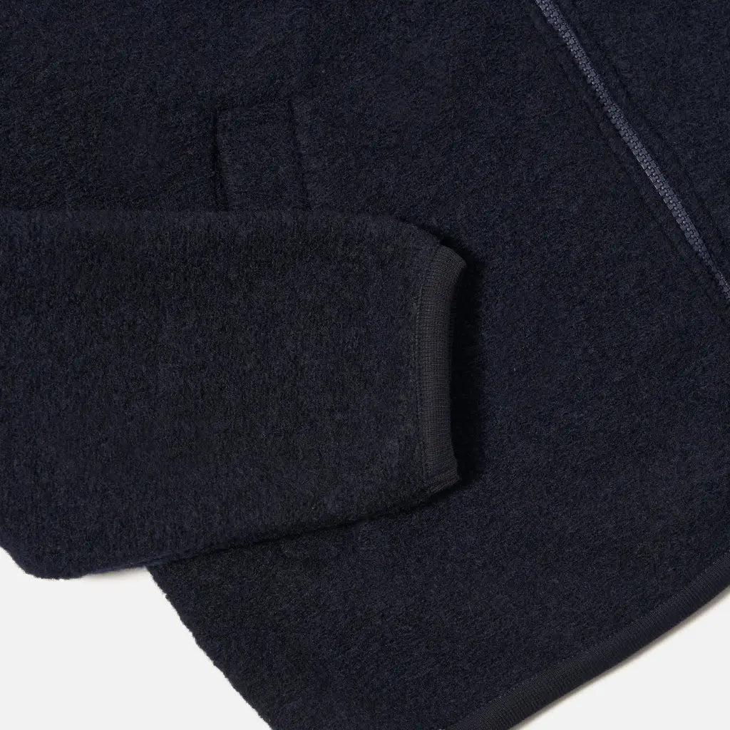 Poignet côtelé et poche passepoilée du Zip Bomber en laine bouillie bleu marine